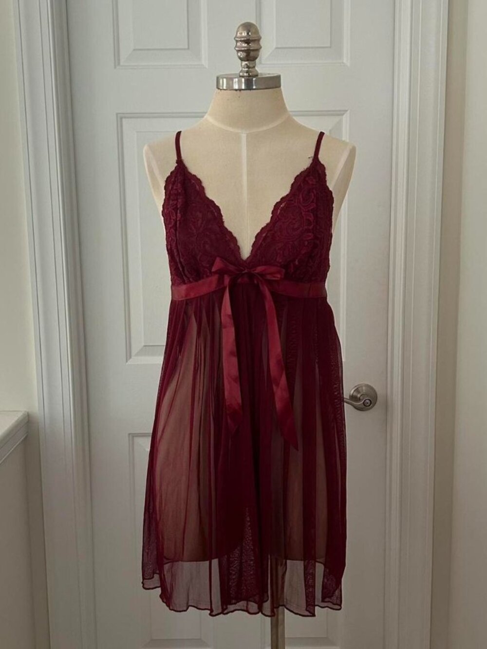 Burgundy lace babydoll dress with bow detail.